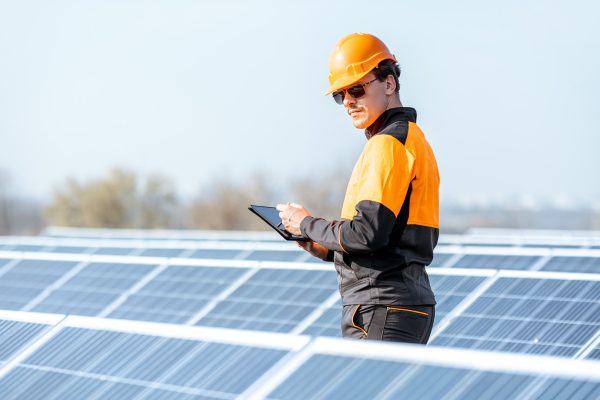 engineer-servicing-solar-panel-on-electric-plant-6DG9SQ4.jpg
